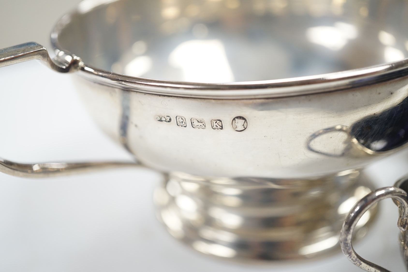 A George V silver two handled bowl and two pairs of early 20th century silver condiments. Condition - poor to fair